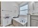 Modern bathroom featuring a soaking tub with tile surround, chrome fixtures, and natural light at 1817 Snaresbrook Way, Orlando, FL 32837