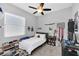 Cozy bedroom with a ceiling fan, carpeted floors, and a large window letting in natural light at 1817 Snaresbrook Way, Orlando, FL 32837