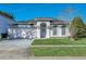 Charming single-story home with well-maintained lawn and blue trim, enhancing its curb appeal at 1817 Snaresbrook Way, Orlando, FL 32837
