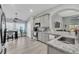 Modern kitchen with gray cabinets, granite countertops, stainless steel appliances, and adjacent dining area at 1817 Snaresbrook Way, Orlando, FL 32837