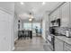 Well-lit kitchen with gray cabinets, stainless steel appliances, and a cozy dining nook at 1817 Snaresbrook Way, Orlando, FL 32837