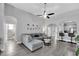 Bright living room with a gray sectional, open floor plan, and easy access to the kitchen and other living spaces at 1817 Snaresbrook Way, Orlando, FL 32837