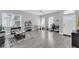 Bright living room featuring wood-look floors, large windows, and contemporary decor at 1817 Snaresbrook Way, Orlando, FL 32837