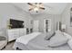 Bright and airy main bedroom with a comfortable bed, modern dresser, and seamless flow to the en-suite bathroom at 1817 Snaresbrook Way, Orlando, FL 32837