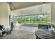 The screened-in patio features views of a lovely pond, outdoor seating, ceiling fans and concrete flooring at 1817 Snaresbrook Way, Orlando, FL 32837