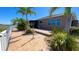 Wide backyard featuring brick-paved areas, tropical plants, and a well-maintained exterior at 1855 Partin Terrace Rd, Kissimmee, FL 34744