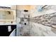 Bathroom walk-in shower featuring marble design, black shower head and tiled walls and floor at 1855 Partin Terrace Rd, Kissimmee, FL 34744