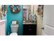 Stylish half-bathroom with blue walls, decorative seashell accents, and elegant fixtures at 1855 Partin Terrace Rd, Kissimmee, FL 34744