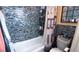 This bathroom shower features eye catching blue glass tile at 1855 Partin Terrace Rd, Kissimmee, FL 34744