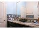 This bathroom has double sinks with granite counters and decorative tiling at 1855 Partin Terrace Rd, Kissimmee, FL 34744