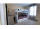 This bedroom includes a white bunk bed with a basketball hoop on top bunk at 1855 Partin Terrace Rd, Kissimmee, FL 34744
