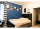 Cozy bedroom with dark wood furniture, accent wall, and decorative sports-themed wall art at 1855 Partin Terrace Rd, Kissimmee, FL 34744