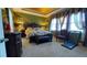 Spacious bedroom showcasing a decorative tray ceiling, a floral bedspread, and natural lighting at 1855 Partin Terrace Rd, Kissimmee, FL 34744