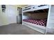 This bedroom includes a white bunk bed with a basketball hoop on top bunk at 1855 Partin Terrace Rd, Kissimmee, FL 34744