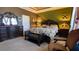 Luxurious bedroom featuring a floral bedspread, a dark wood dresser, and a stylish accent chair at 1855 Partin Terrace Rd, Kissimmee, FL 34744