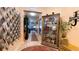 Elegant entryway with decorative mirror, display cabinet, and tasteful decor create a welcoming ambiance at 1855 Partin Terrace Rd, Kissimmee, FL 34744