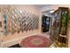 Elegant entryway featuring a stylish mirror accent wall and a display cabinet that adds charm and sophistication at 1855 Partin Terrace Rd, Kissimmee, FL 34744