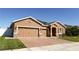 Attractive single-story home featuring a three-car garage, solar panels and a well-maintained front yard at 1855 Partin Terrace Rd, Kissimmee, FL 34744