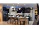 Modern kitchen featuring a breakfast bar island, pendant lights, modern appliances, and dark cabinetry at 1855 Partin Terrace Rd, Kissimmee, FL 34744