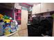 Organized laundry room boasts modern washer/dryer, ample storage cabinets, and shelving for supplies at 1855 Partin Terrace Rd, Kissimmee, FL 34744