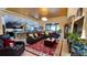Cozy living area featuring a large sectional sofa, a kitchen view, and a decorative tray ceiling with modern light fixture at 1855 Partin Terrace Rd, Kissimmee, FL 34744