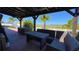 Outdoor seating area under a pergola with a view of the landscaped backyard at 1855 Partin Terrace Rd, Kissimmee, FL 34744