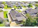 Aerial view of home showcasing new solar panels, backyard landscaping, and the neighborhood at 188 Whispering Pines Way, Davenport, FL 33837