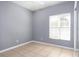 This bedroom features neutral-colored walls and tile flooring, with natural light from a large window at 188 Whispering Pines Way, Davenport, FL 33837