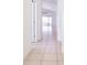 Hallway featuring neutral tile flooring leading to the living area, creating a seamless transition at 188 Whispering Pines Way, Davenport, FL 33837