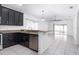 Kitchen with stainless steel dishwasher, breakfast bar and dark wood cabinets at 188 Whispering Pines Way, Davenport, FL 33837