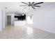 Bright living room featuring tile floors, a modern ceiling fan and open access to the kitchen at 188 Whispering Pines Way, Davenport, FL 33837