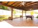 Spacious covered patio with a wooden pergola, a pool table, and hanging swings at 188 Whispering Pines Way, Davenport, FL 33837