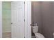 Small toilet room with toilet and a view of a walk in closet with wire shelving at 188 Whispering Pines Way, Davenport, FL 33837