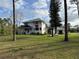 Exterior front view of the home with a lovely porch and yard at 1955 Mustang Ct, St Cloud, FL 34771