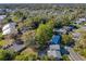 An aerial view highlights neighborhood layout, abundant trees, nearby parking, and community location at 210 Carriage Hill Dr, Casselberry, FL 32707