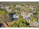 A neighborhood is shown from above, highlighting street layout, tree coverage, and private pools at 210 Carriage Hill Dr, Casselberry, FL 32707