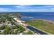 Aerial view of a lakefront community with a beach and surrounding residential neighborhood at 24 Cypress Ave, St Cloud, FL 34769
