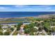 Aerial view of the property with a pool, beautiful landscaping and lake views at 24 Cypress Ave, St Cloud, FL 34769