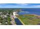 Aerial view of a waterfront community with a beach, lake, park and surrounding neighborhood at 24 Cypress Ave, St Cloud, FL 34769