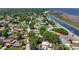 Aerial view of the property and surrounding neighborhood, with a scenic canal nearby, highlighting its desirable location at 24 Cypress Ave, St Cloud, FL 34769