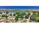 Aerial view of the property in a residential area, featuring green trees and waterways in the background at 24 Cypress Ave, St Cloud, FL 34769