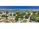 Aerial view of the property in a residential area, featuring green trees and waterways in the background at 24 Cypress Ave, St Cloud, FL 34769