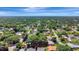 Aerial view of the property highlighting its location within a neighborhood surrounded by lush greenery at 24 Cypress Ave, St Cloud, FL 34769