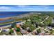 Aerial view showcasing the property's location near a lake with trees and well-maintained landscaping at 24 Cypress Ave, St Cloud, FL 34769