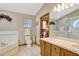Bathroom featuring double sinks, a soaking tub, tiled floors, and neutral paint at 24 Cypress Ave, St Cloud, FL 34769