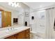 Bathroom featuring wood cabinets, a white countertop, and a shower-tub combo at 24 Cypress Ave, St Cloud, FL 34769