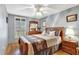 Bedroom with blue walls, hardwood floors, and bright natural light streaming through shuttered windows at 24 Cypress Ave, St Cloud, FL 34769