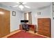 Bedroom featuring a desk with dual monitors and a large wood dresser at 24 Cypress Ave, St Cloud, FL 34769