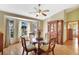 Cozy dining room with a round glass table, wooden chairs, and a bay window for natural light at 24 Cypress Ave, St Cloud, FL 34769