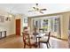 Bright dining area featuring a glass table, bay window, and wood-look floors; perfect for Gathering gatherings at 24 Cypress Ave, St Cloud, FL 34769